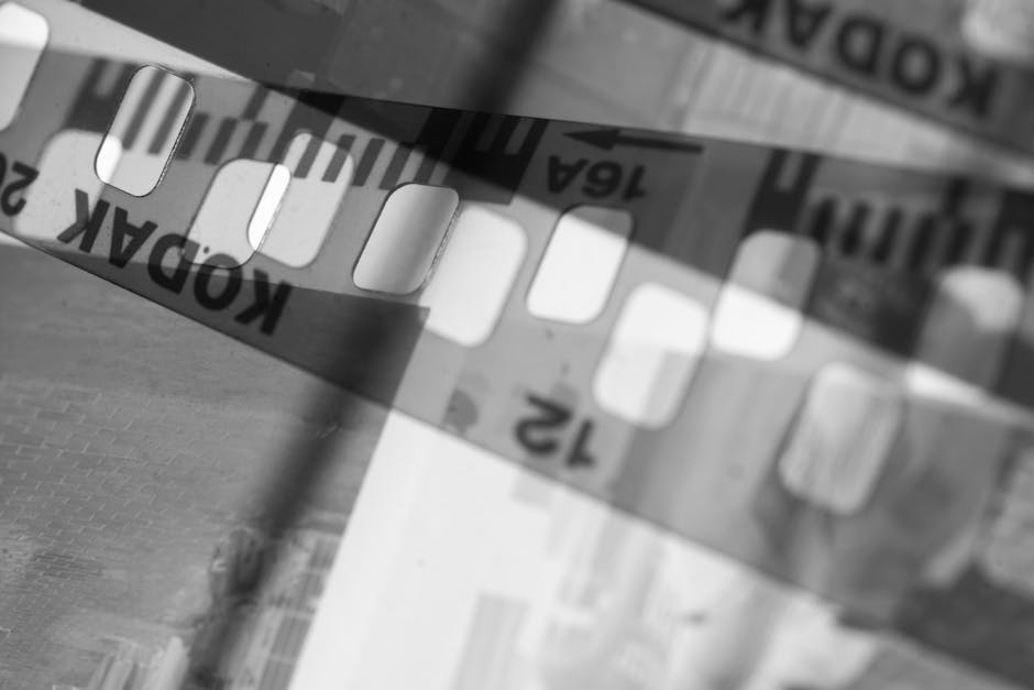 Black and white abstract photo of a Kodak filmstrip, highlighting film photography's nostalgia.